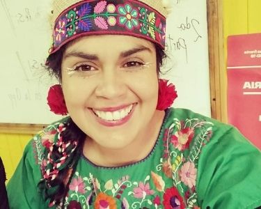 Fotografía de Carolina Sandoval en traje típico mapuche, también se puede ver una imagen del títere esperancita huerta. Fotos cortesía de Carolina Sandoval