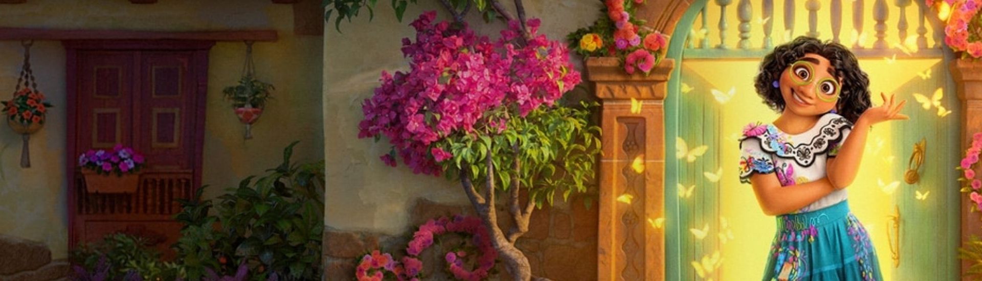 Imagen del personaje Mirabel Madrigal, protagonista de la película de Disney Encanto. En la imagen se ve de fondo una casa llena de flores.