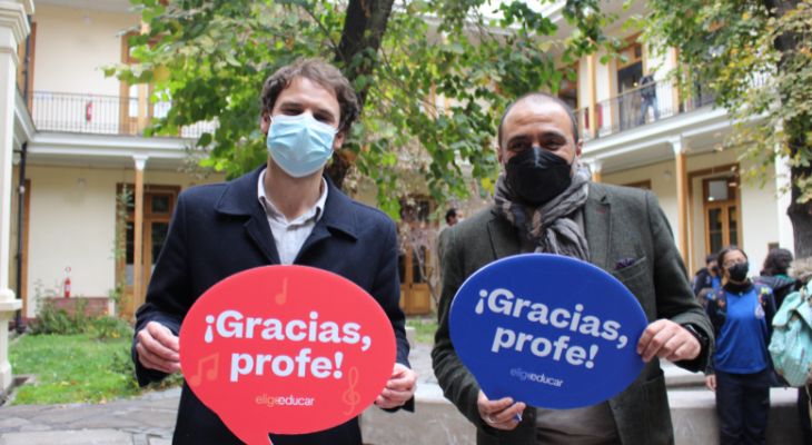 Fotografía de Joaquín Walker y Marco Ávila, ministro de educación. Sostienen unos carteles que dIcen gracias profe